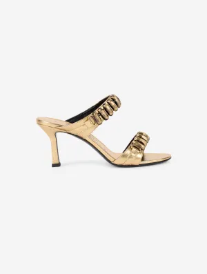 Mules in gold metallic leather