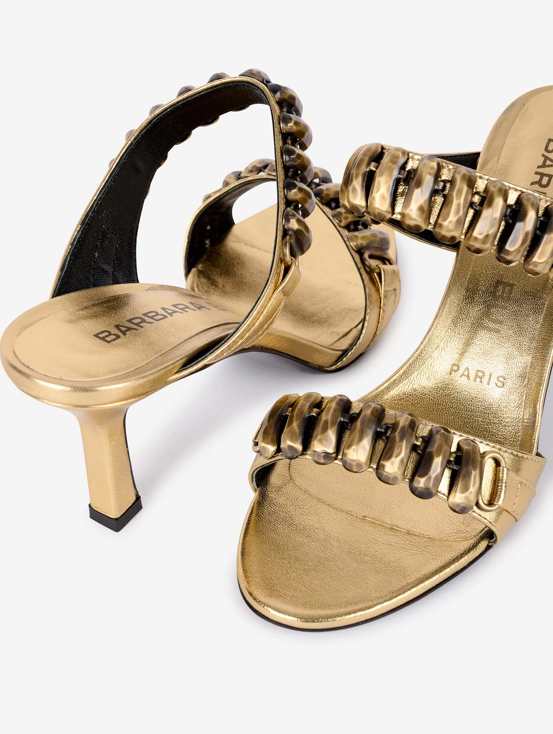 Mules in gold metallic leather